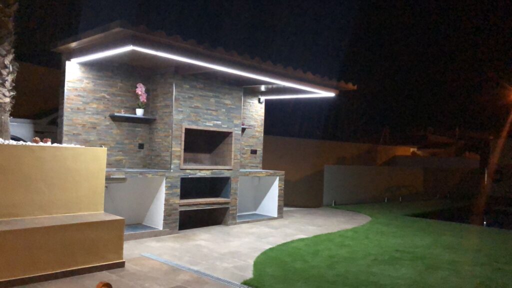 Garden design project with barbecue area and modern ambient lighting