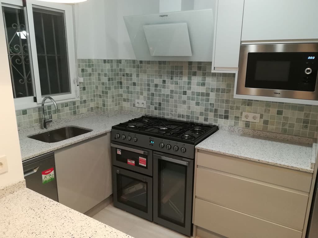 Corner coastal kitchen renovation with extra large oven and glass extractor