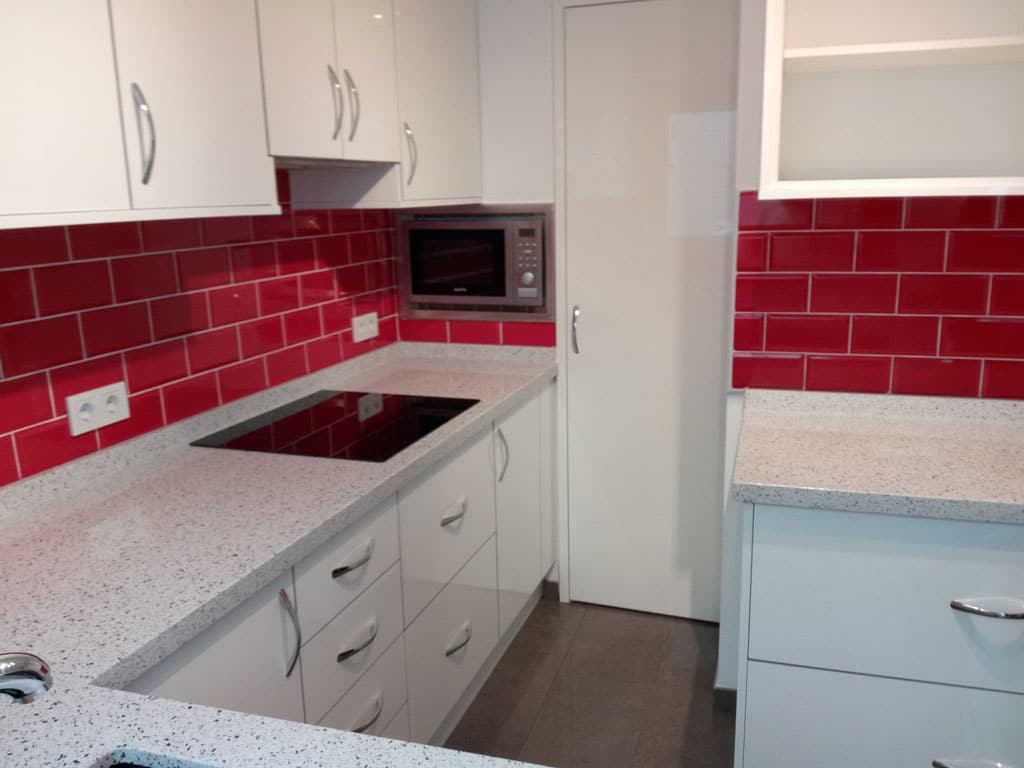 White kitchen cabinets and red tiles design